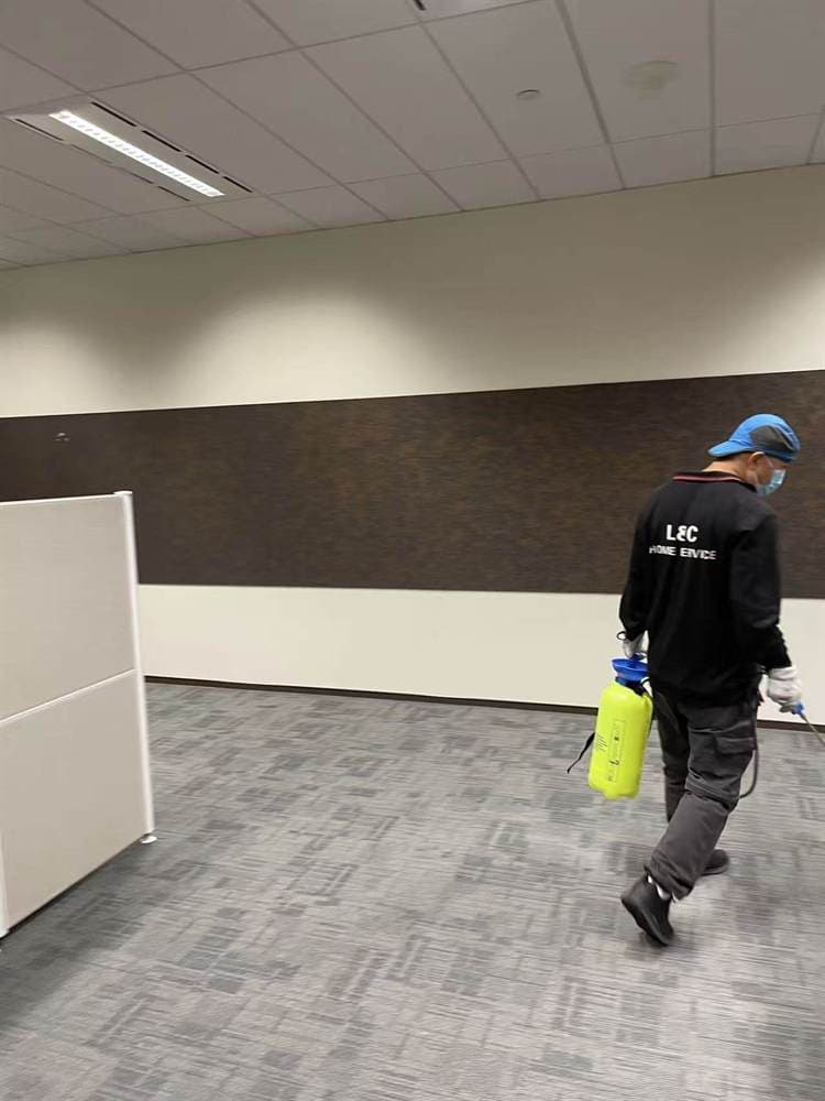 Technician carrying out pest control treatment in a Sydney commercial office